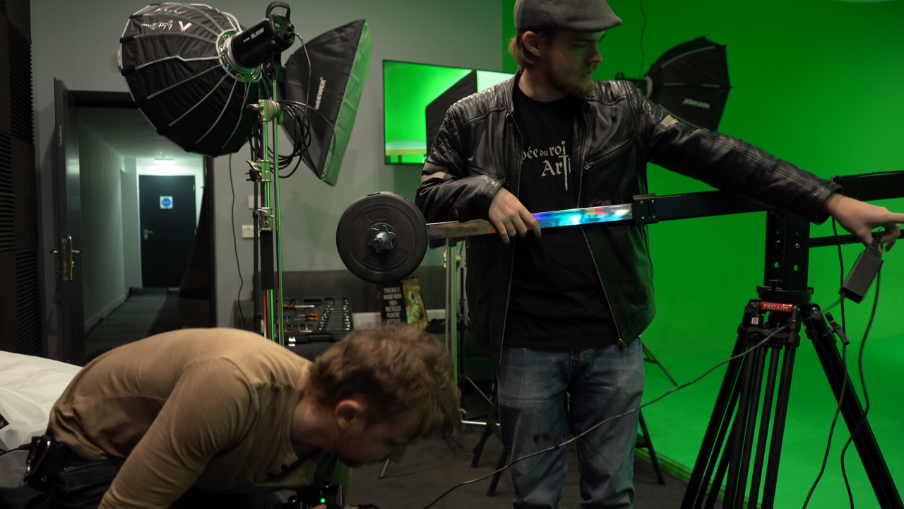 Rigging lights in a green screen studio